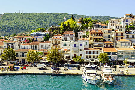 two white yacht near white concrete buildings at daytime thumbnail