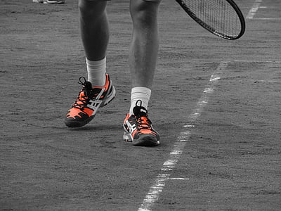 selective color photography of orange-and-white athletic shoes thumbnail