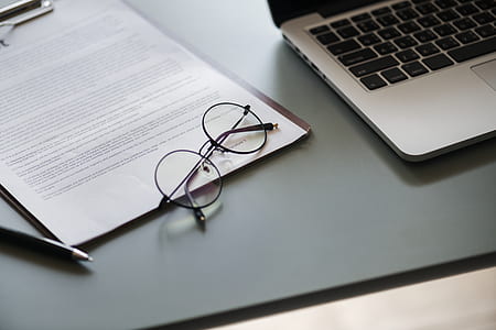 black framed hippie eyeglasses on white printing paper beside laptop computer thumbnail
