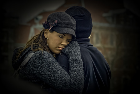 woman hugging person in black hat thumbnail