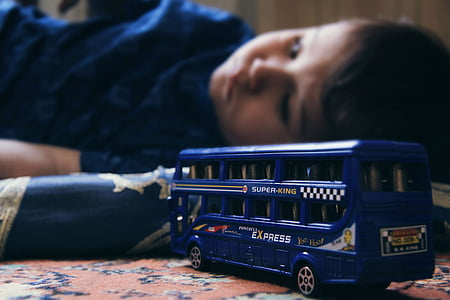 blue bus die-cast toy and boy force focus photography thumbnail