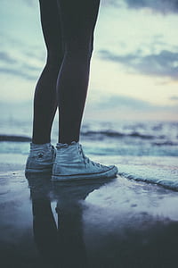 worm's eye view of person standing at seashore thumbnail