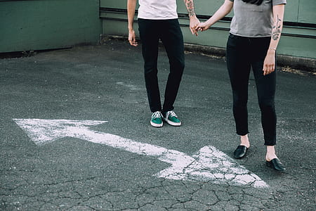woman and man holding hands together while standing thumbnail