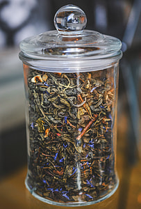 tilt shift photo of clear glass canister filled with dried pastries thumbnail