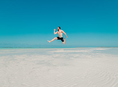man jumping on body of water at daytime thumbnail