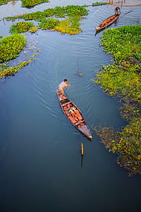 Two Person Riding Black Wooden Boats thumbnail
