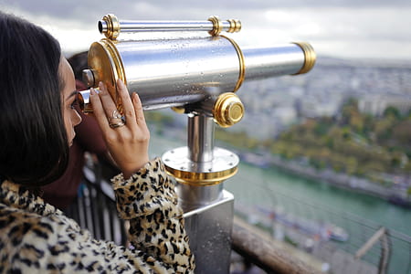 woman taking a peek on coin operated telescope thumbnail