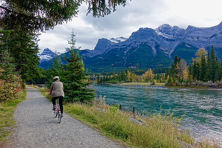 Rear View of Woman Walking on Mountain Road thumbnail