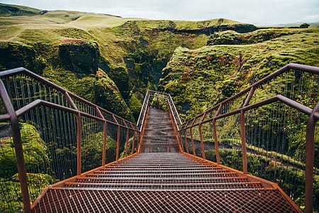 A viewing platform with staircase surrounded by green cliffs thumbnail