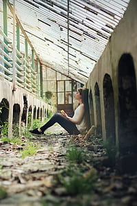 woman sitting while leaning on wall thumbnail