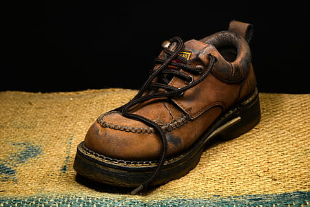 unpaired brown leather work boot thumbnail