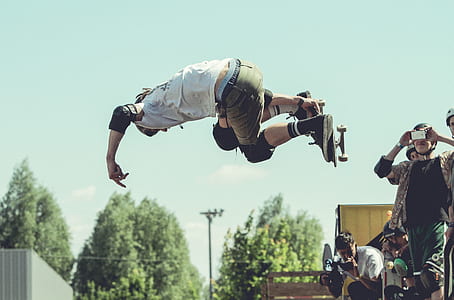 man taking photo of person skateboarding thumbnail