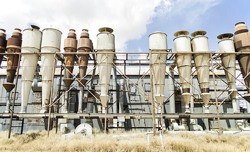 worm's-eye view of factory under cloudy sky thumbnail