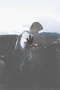 person standing while carrying backpack during daytime thumbnail