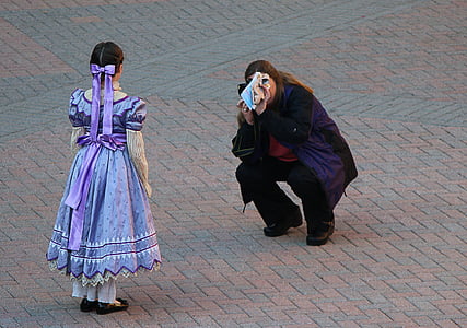 woman taking photo of girl wearing lavender-colored gown thumbnail