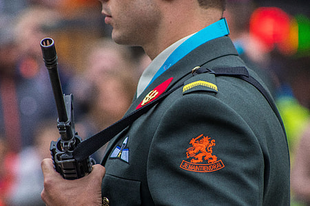 man holding black assault rifle in shallow focus photography thumbnail