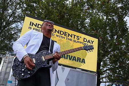 man playing black electric guitar thumbnail