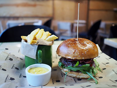 hamburger and fries on top of table thumbnail