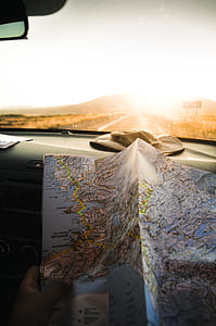 person holding terrestrial map inside car thumbnail