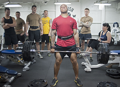 man wearing red shirt carrying barbell thumbnail