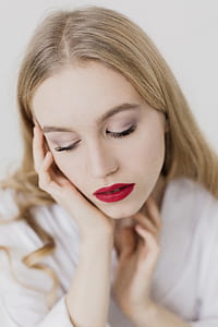 Close Up Photo of a Woman With Blonde Hair Wearing White Bathrobe thumbnail