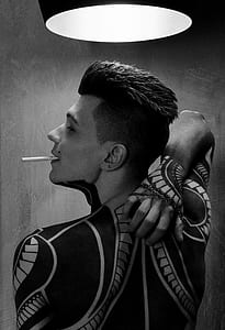 grayscale photo of man scratching back thumbnail