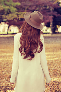 woman in white , strolling across a park thumbnail
