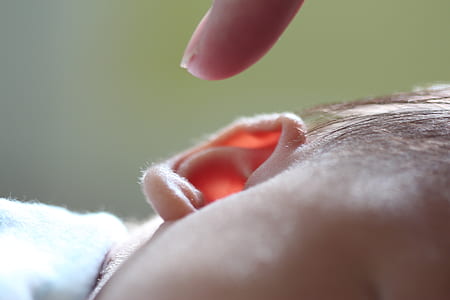 finger hovering over child's right ear thumbnail