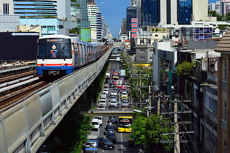 white train over city street thumbnail