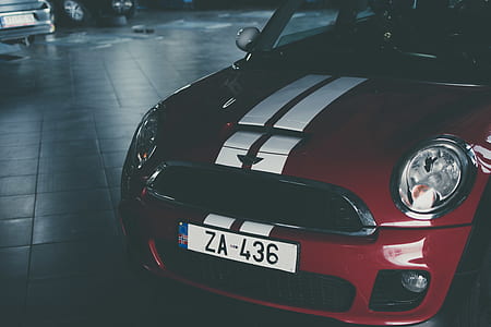 red and white vehicle parks on gray ceramic pavement thumbnail