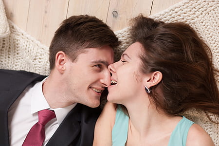 photo of woman biting man's nose thumbnail