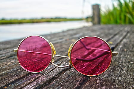 round silver-colored pink tinted sunglasses on grey wooden board thumbnail