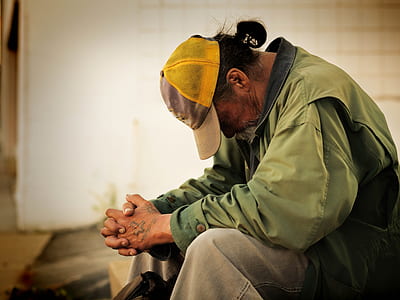 man wearing green jacket and yellow tracker cap thumbnail