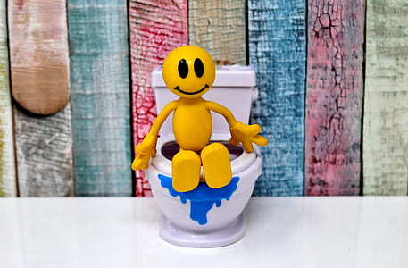 yellow stick man sitting on toilet wallpaper thumbnail