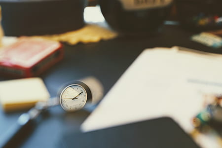 selective focus photography of round clock thumbnail
