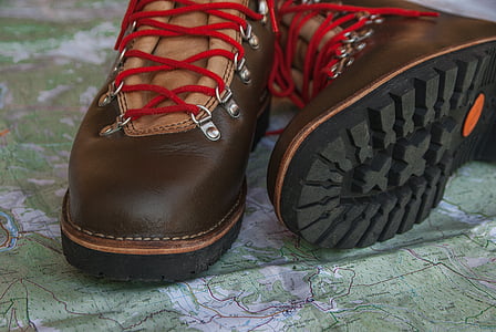 brown-and-black leather work boots on green textile thumbnail
