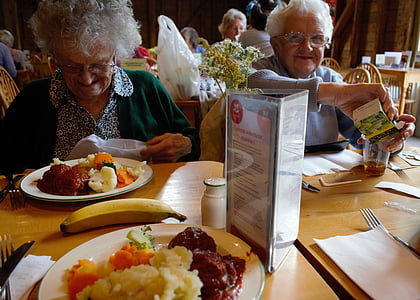 two women sitting front of table thumbnail