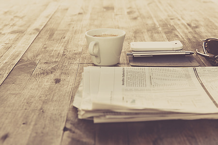 white printer paper beside white ceramic mug thumbnail