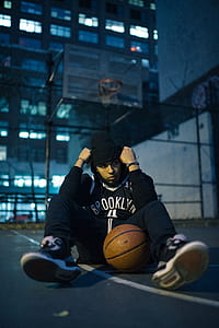man sitting on floor with basketball thumbnail