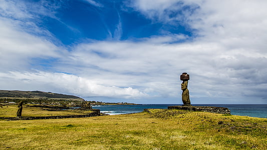 brown concrete statue near sea during daytime thumbnail
