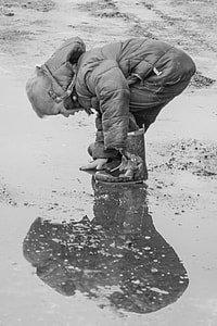 boy in bubble jacket reaching the floor thumbnail