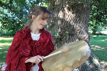 woman playing brown percussion instrument thumbnail