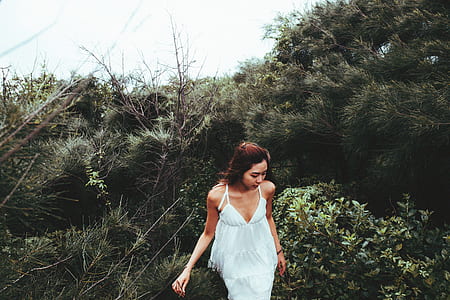 woman standing in the middle of green grasses thumbnail