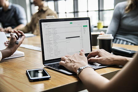 person in front of laptop computer on table thumbnail