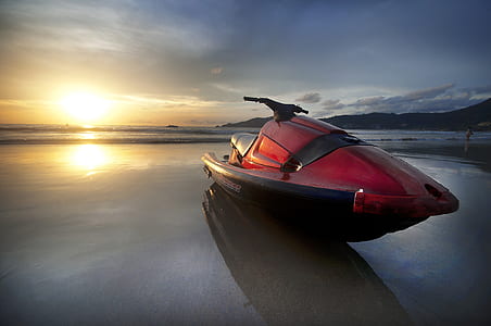 empty red and black person watercraft on sand thumbnail