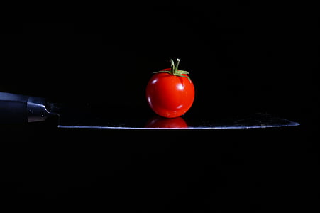 red tomato on black surface thumbnail