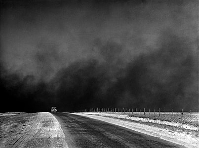 car in the middle of road grayscale photography thumbnail