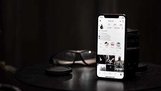 space gray iPhone X on brown wooden table thumbnail