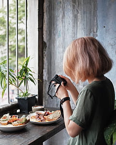 woman steering at camera near food thumbnail