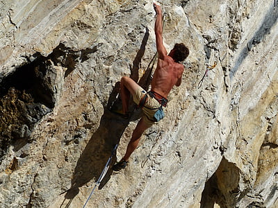 man climbing mountain during daytime thumbnail